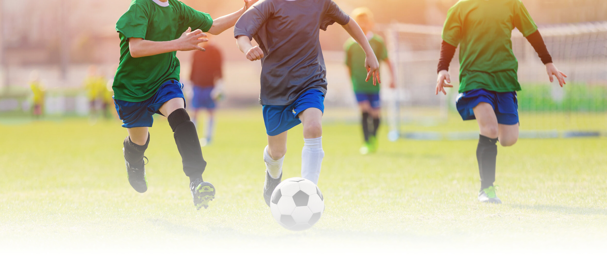 Running-Soccer-Football-Players-During-the-Sunrise.-Footballers-Kicking-Football-Match.-Soccer-School-Tournament.-Young-Soccer-Players-Running-After-the-Ball.-Soccer-Stadium-in-the-Background-1149107109_2671x1126.jpg_6387